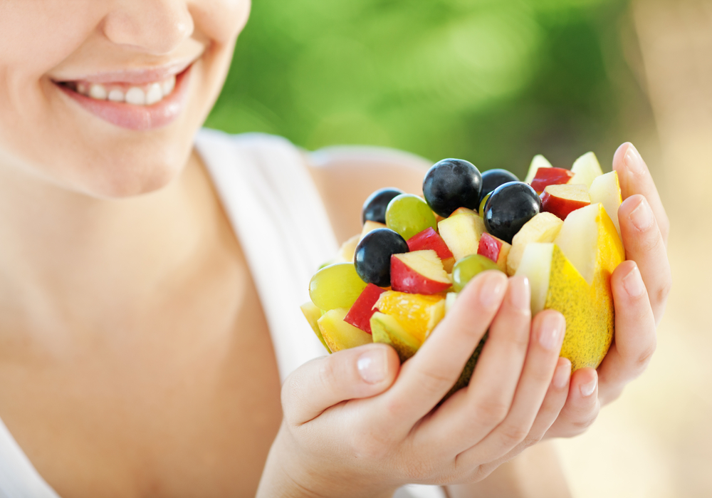 Happy,Young,Woman,Holding,Fresh,Fruits,Served,In,Melon,Bowl